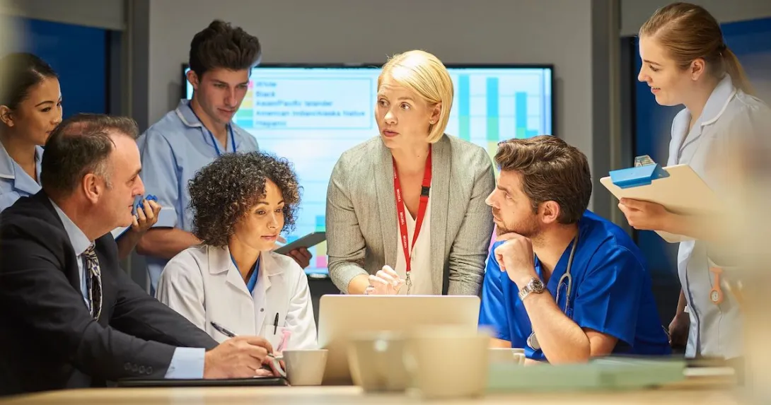 Doctors and hospital administrators discussing data.
