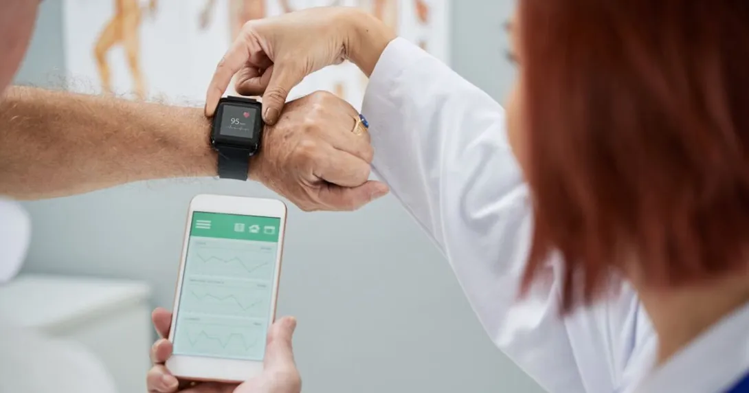A doctor helping set up a patient's smartwatch.