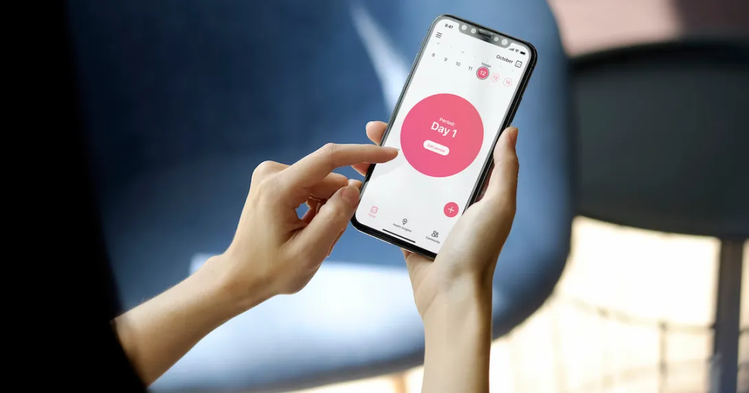 A woman using the Flo period tracker