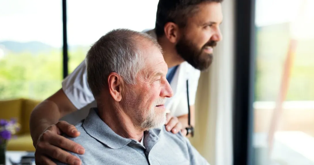 An older man with a companion at home
