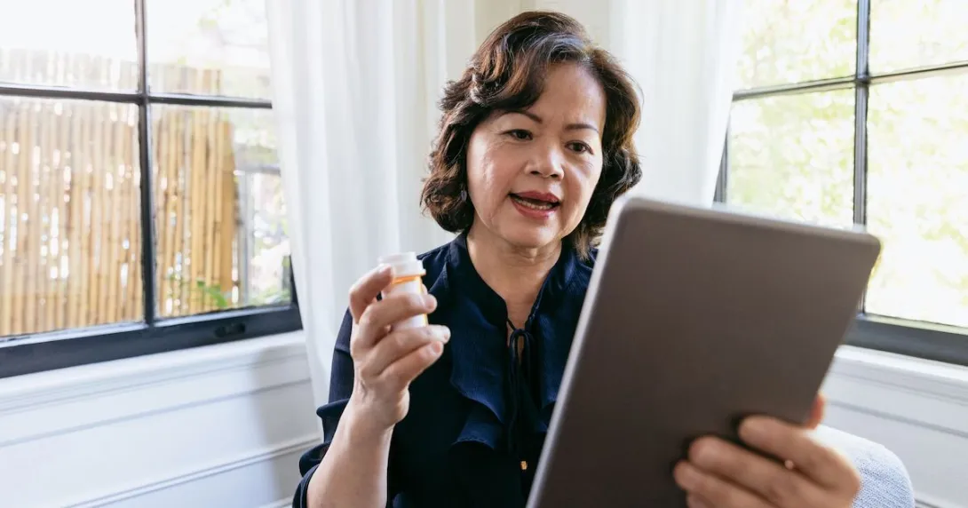 A  woman talking to a provider using a tablet