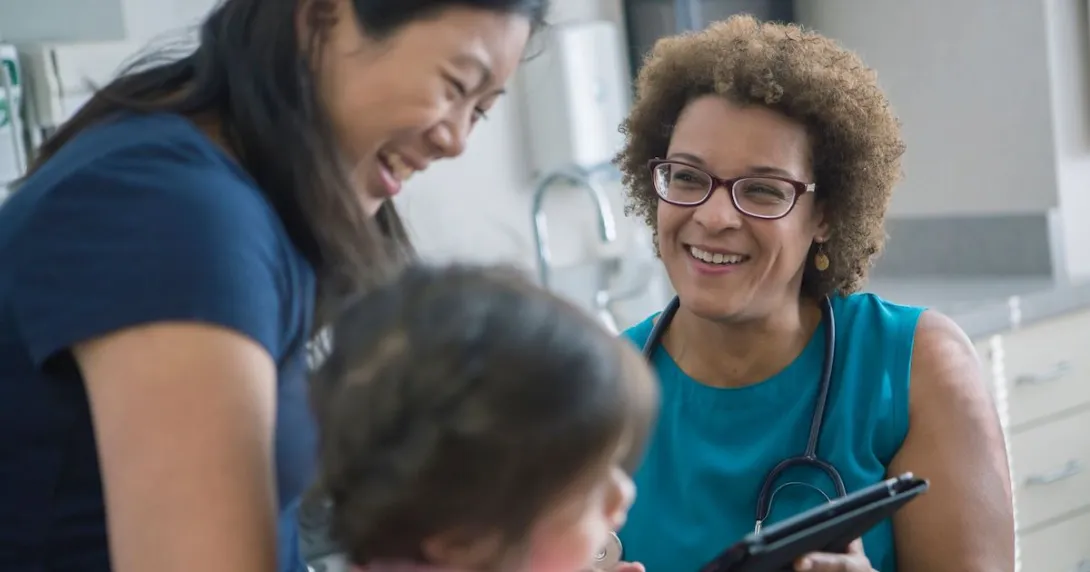 A parent and a child talking to a doctor