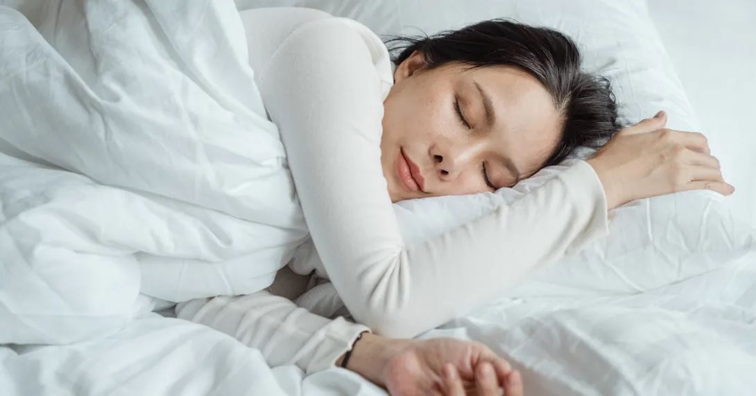 A person sleeping on a bed