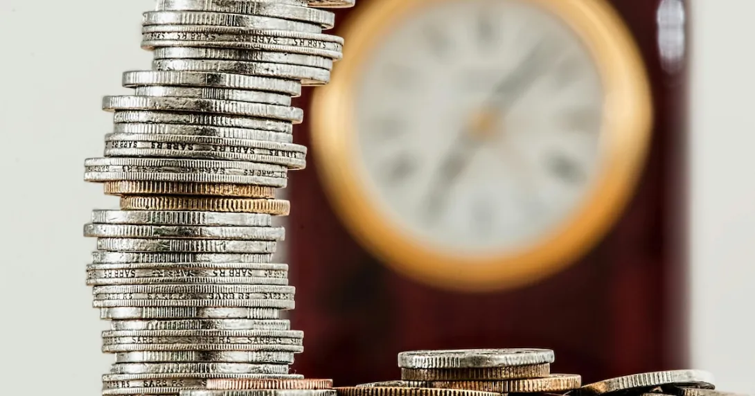 Coins and a clock on background