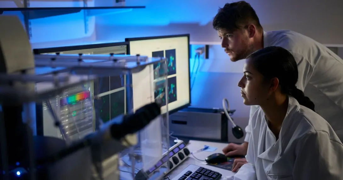 Researchers looking at data on a computer