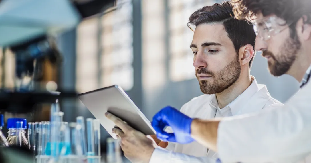 Researchers in a lab using an iPad.