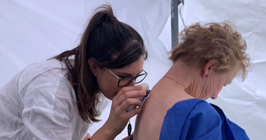 A doctor assessing a patient's skin