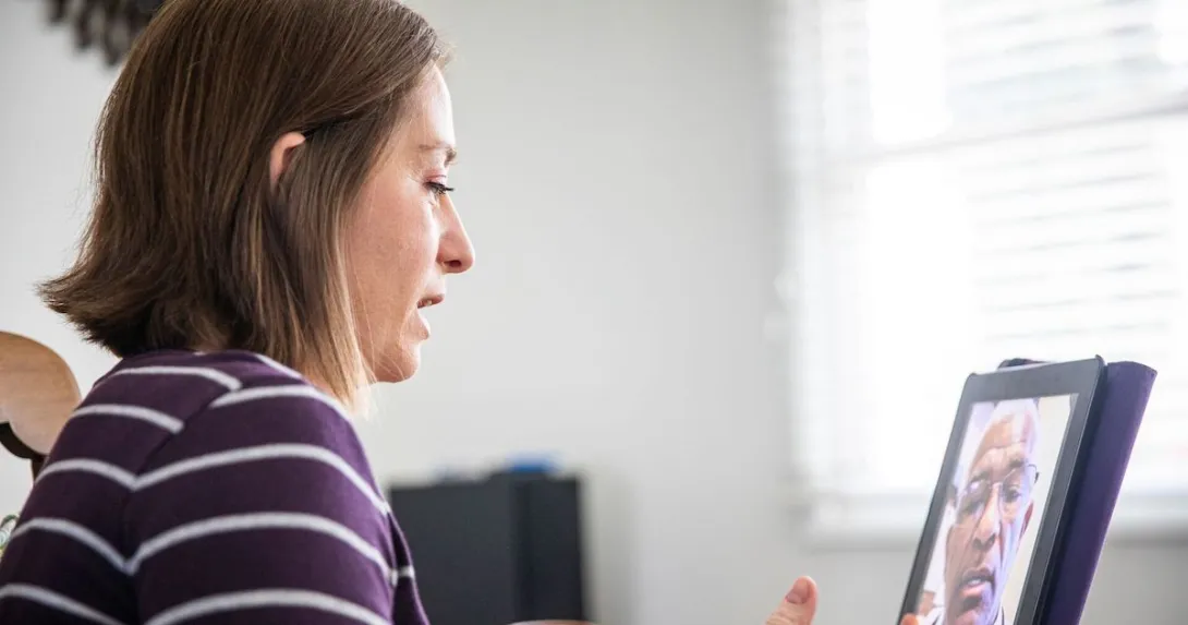 A woman talking to a provider using a tablet