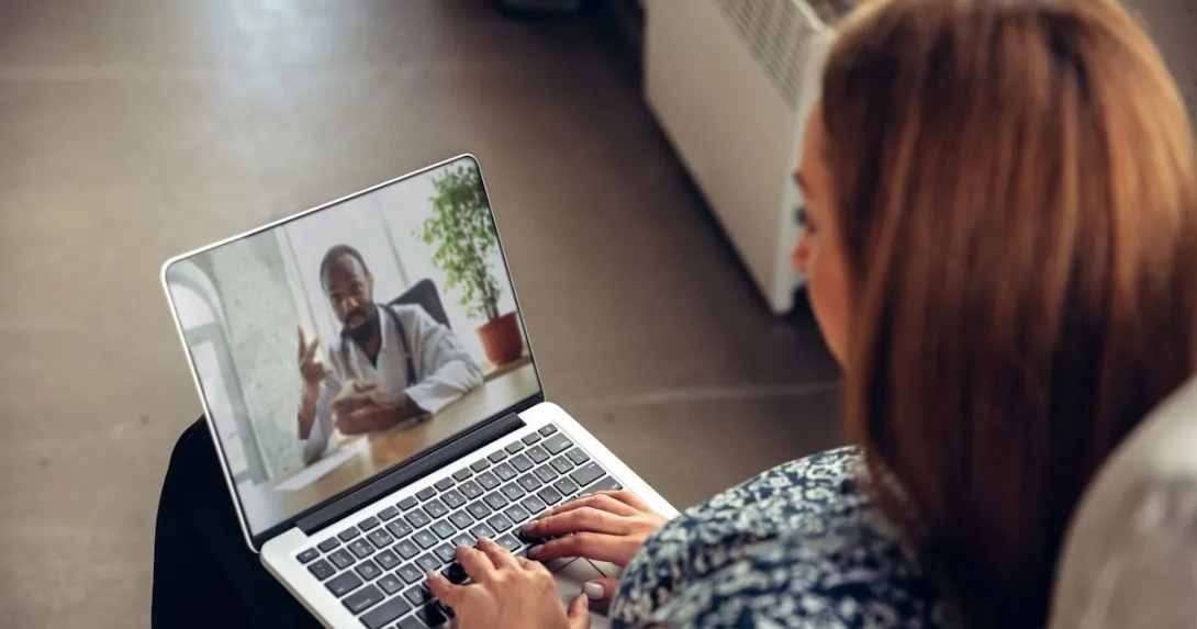 A woman talking to a doctor via telehealth