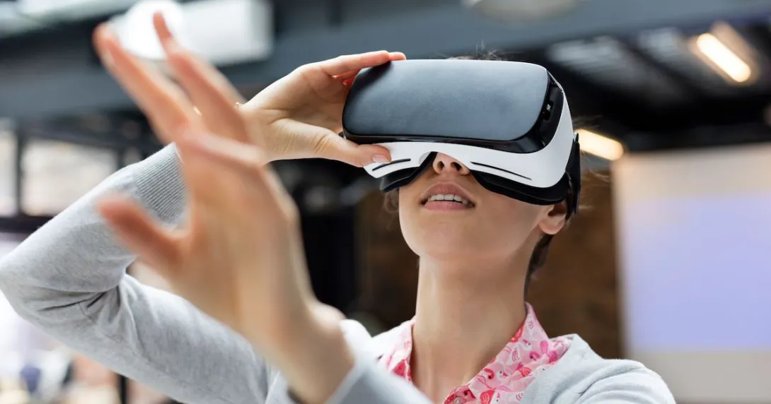 Person using a virtual reality headset with their arms extended above their head