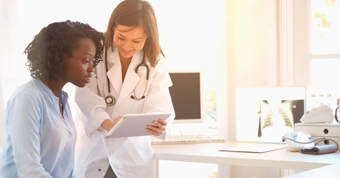 Healthcare provider showing someone a tablet