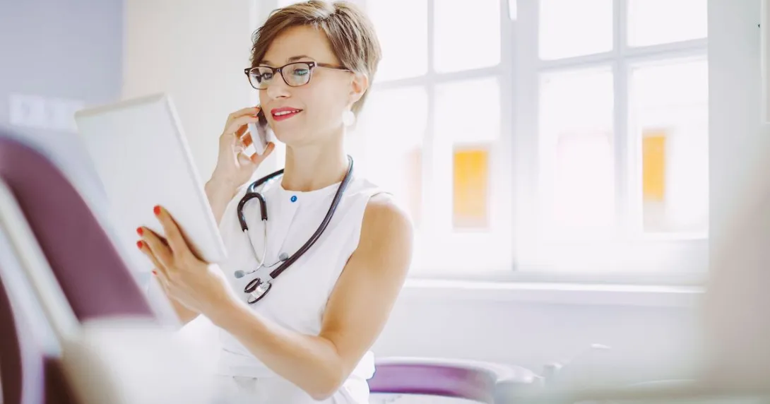 Healthcare provider talking on the phone while looking at a chart