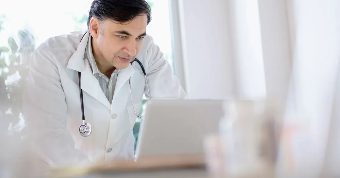 A doctor using a laptop computer