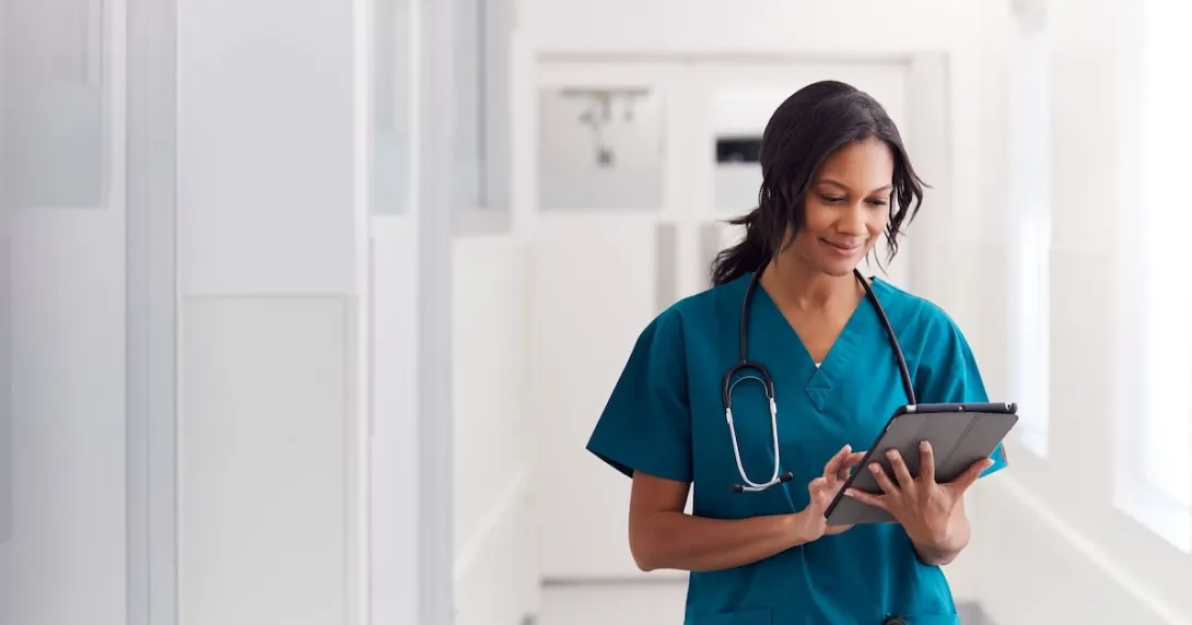 A doctor checking a patient's record on a digital tablet