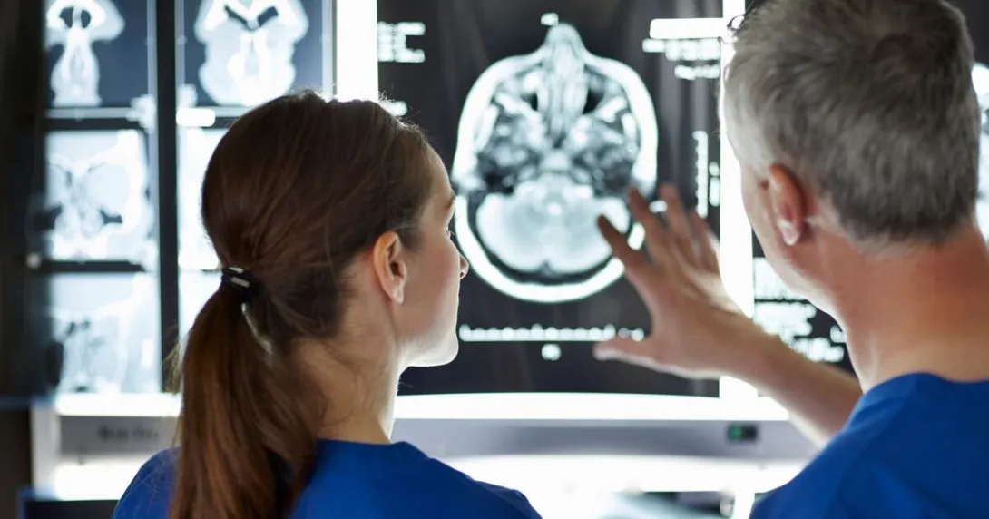 Two radiologists examining an x-ray image