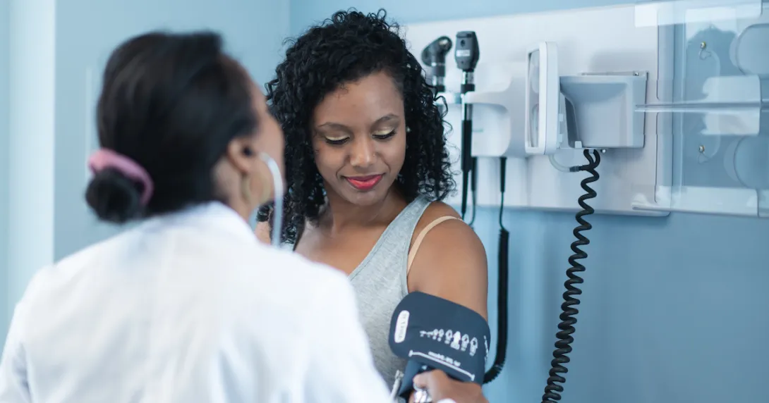 A person getting their blood pressure checked at the doctor's office.