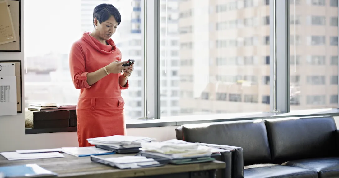 A person using a smartphone at a desk