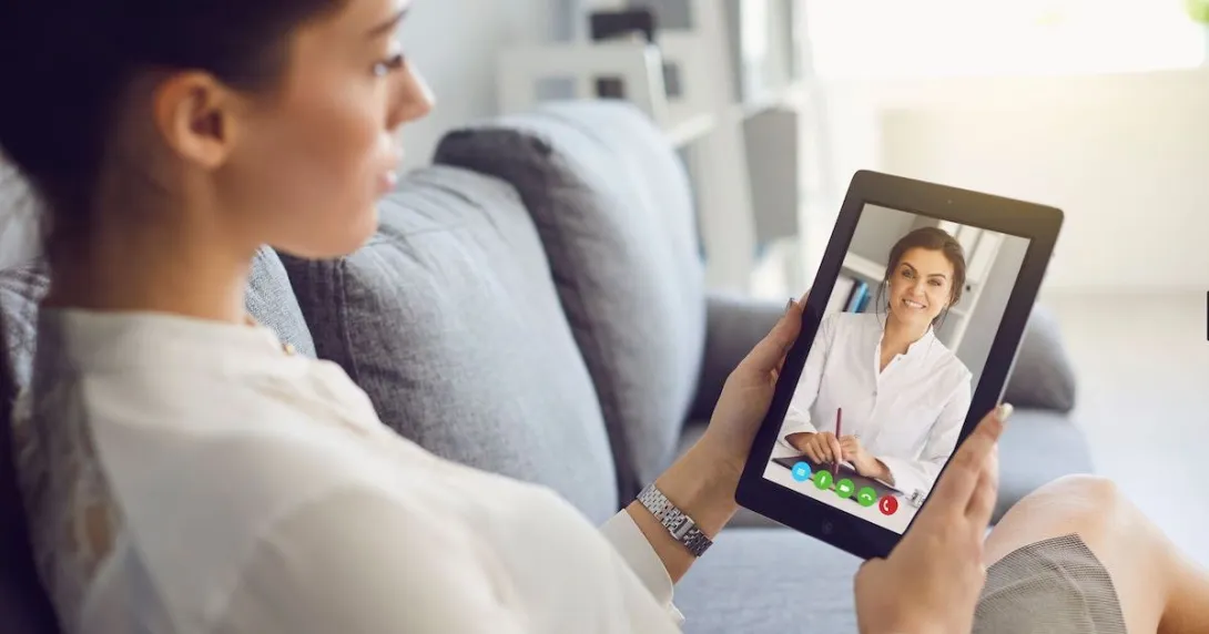 A person talking to a provider via a video chat on a tablet.